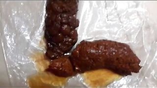 Squirting babe pooping out a hard turd