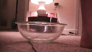 Mature lady pooping in glass bowl