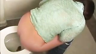 Cute amateur brunette poops in the toilet