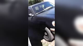 Chunky lady pooping behind the car