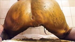 Brunette babe smears shit on her sexy big boobs