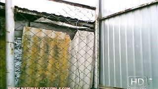 Lady pooping inside the iron fence cage