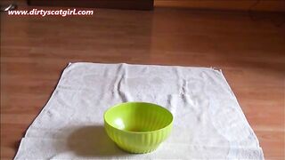 Chubby brunette lady pooping in green bowl