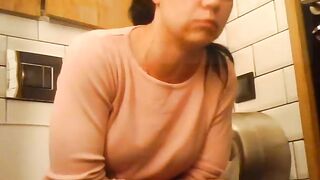 Curvy brunette milf pushing poop