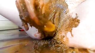 Rubbing shit on her pussy while toying her pooper