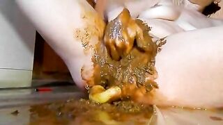 Rubbing shit on her pussy while toying her pooper