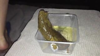 Juicy green long turd in the container