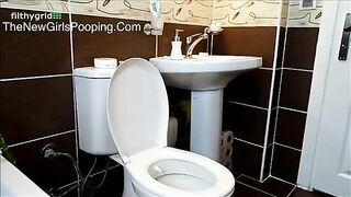 Seductive brunette babe pooping in toilet