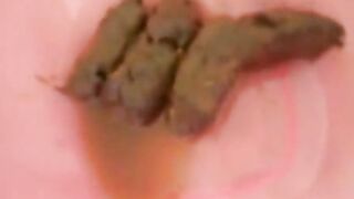 Sexy hot bitch pooping in the plastic bowl