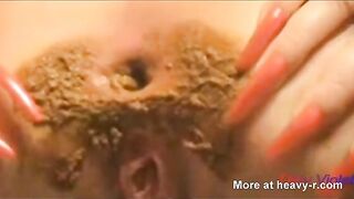 Woman smears shit with her ass