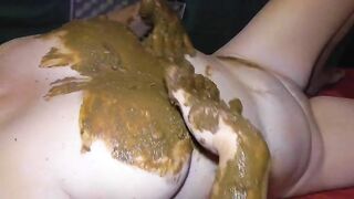 Smearing shit on her boobs