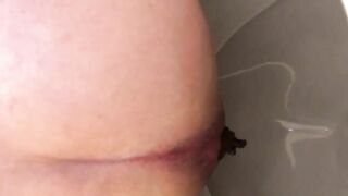 Dark hard juicy turd in the toilet