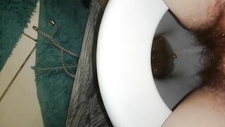 Hairy bitch pooping and pissing