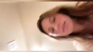 Cute brunette in glasses pooping in toilet