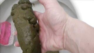 Woman is shitting a very large turd closeup