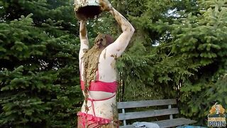 Busty babe masturbating in a bathtub full with cow shit