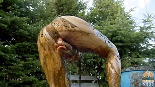 Busty babe masturbating in a bathtub full with cow shit