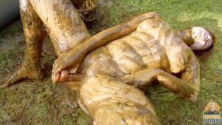 Busty babe masturbating in a bathtub full with cow shit