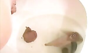 Brunette lady pooping heavily in the toilet