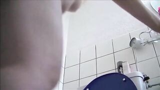 Blonde shitting a long turd in the toilet while standing