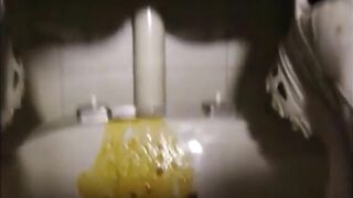 Girl is doing a big squirt of diarrhea in toilet