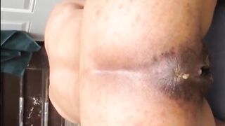 Hairy woman shitting doggystyle closeup