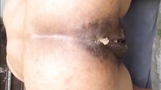 Hairy woman shitting doggystyle closeup