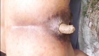 Hairy woman shitting doggystyle closeup