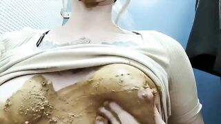 Cute blonde girl smearing shit on her tits