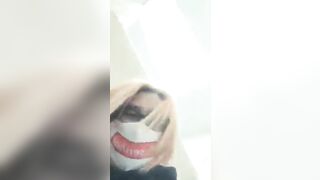 Nerdy lady in glasses and face mask pooping closeup