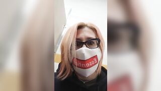 Nerdy lady in glasses and face mask pooping closeup