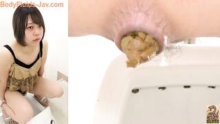 Cute brunette Japanese girl pooping yellow turd
